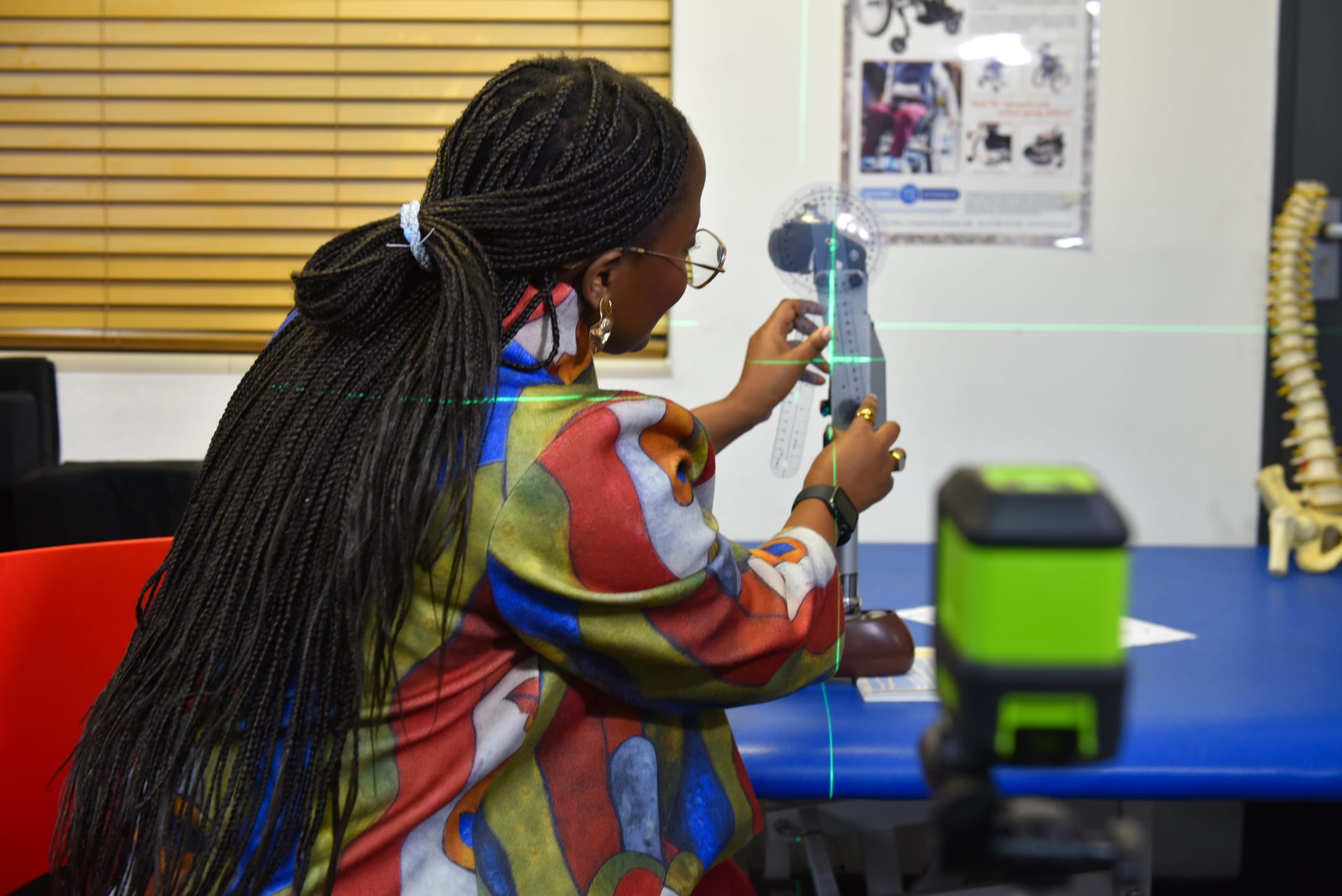 A prosthetist aligning an NK Gen 1 knee with a laser alignment jig